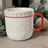 Kép 6/6 - Bögre porcelán karácsonyi fehér színű piros füllel   SDKAE25 dombornyomott 2 féle 8,7x9,3cm